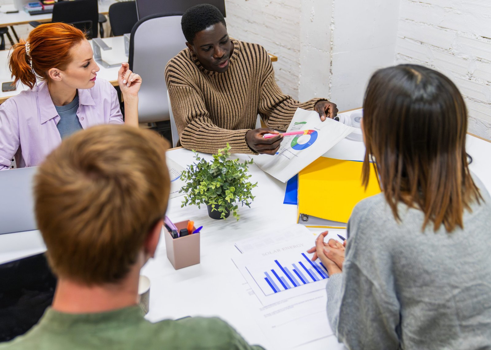 Marketing professionals discussing growth strategies in coworking space